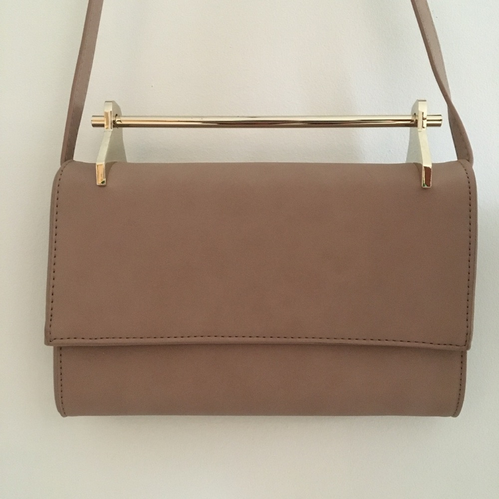 Fold over flap handbag with gold handle and crossbody strap